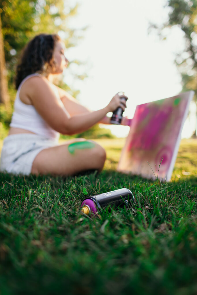 High school senior painting during creative senior photo session in Kansas City