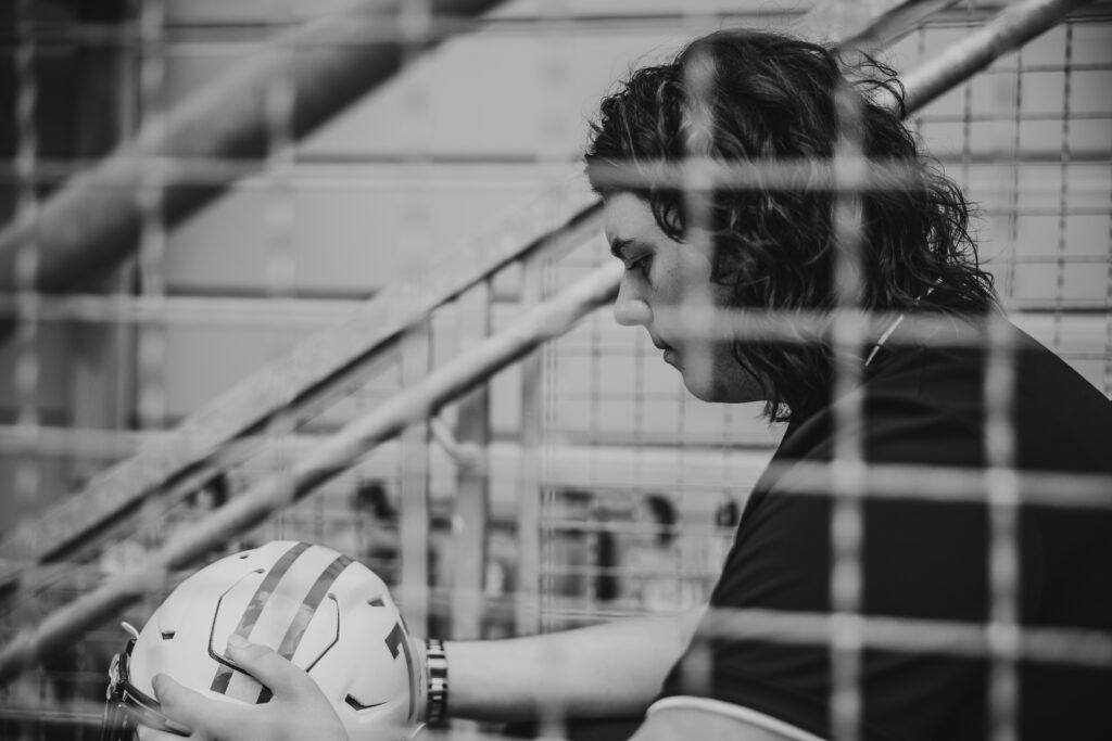 Urban senior session featuring Kansas City football player with helmet