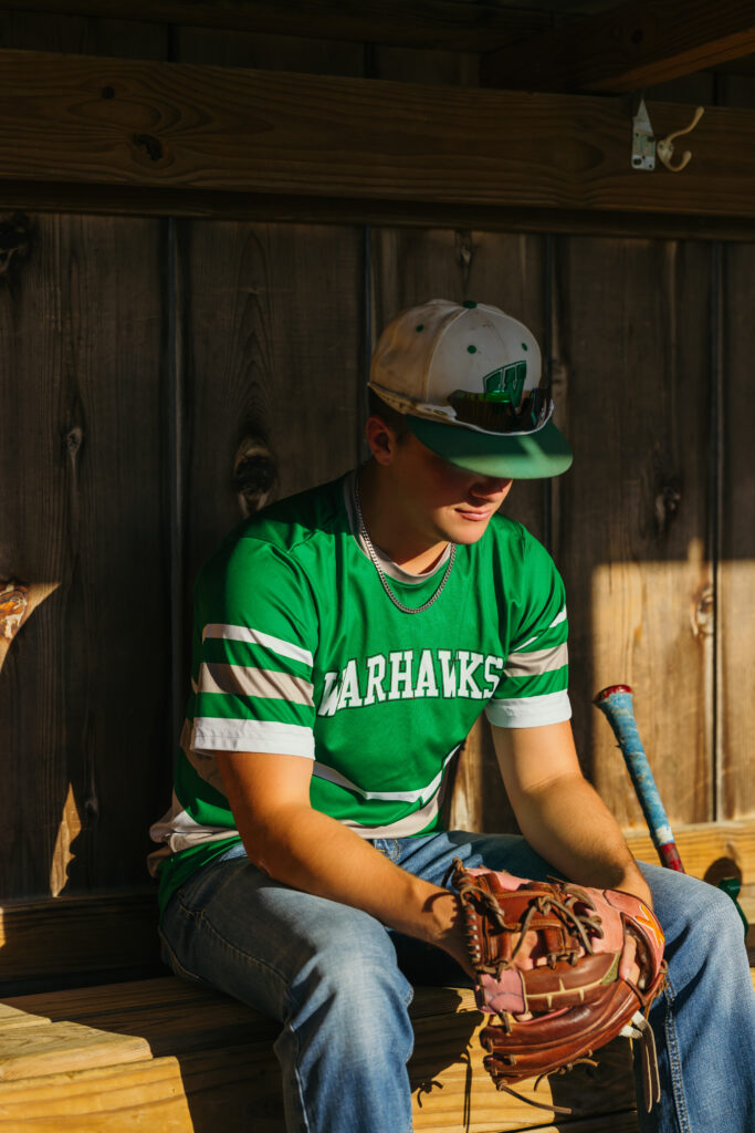 High school senior baseball portraits in dugout and on field in Kansas City