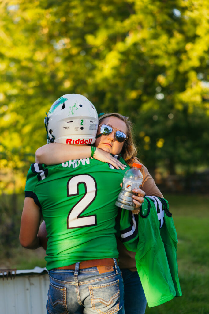 Mother hugging her son during emotional senior portrait session