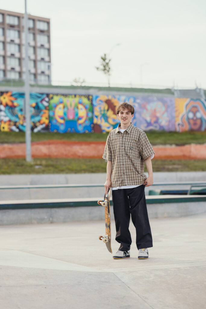 Male senior session in Kansas City featuring skateboarder at local skate park