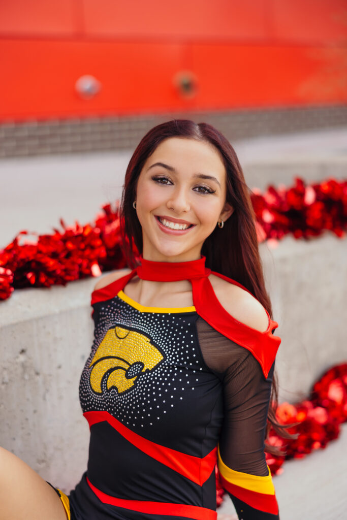Female senior athlete cheerleading session at Kansas City high school field