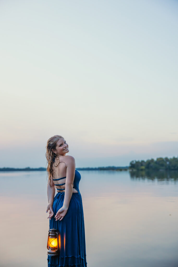 High school senior at a lake during blue hour
