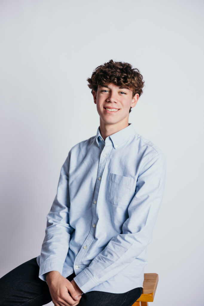 Modern Kansas City senior portraits with clean studio backdrop