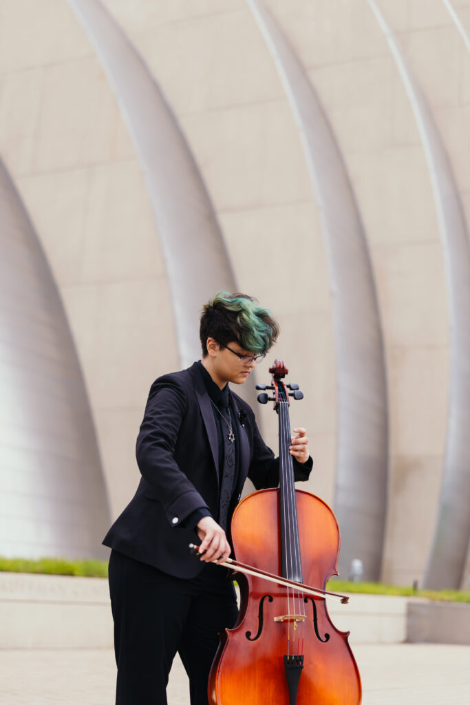 High school senior musician posing outside Kauffman Center during Kansas City senior session