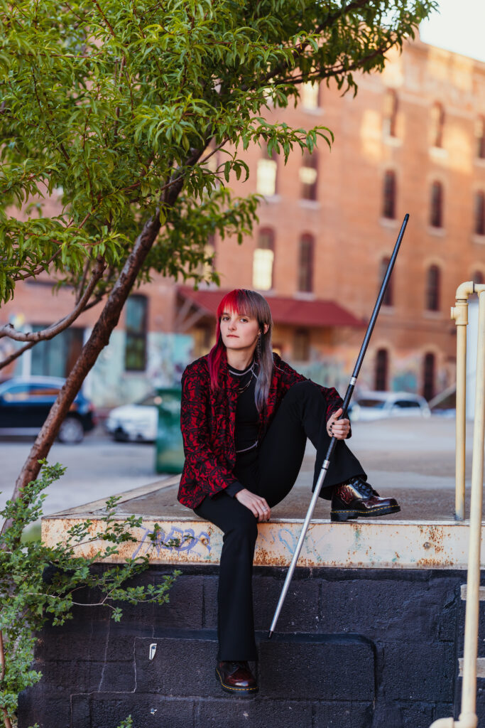 High school senior girl with bo staff in urban setting