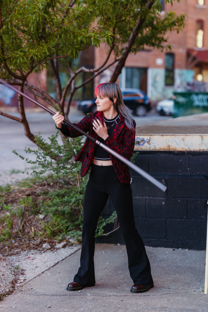Kansas City senior photos featuring taekwondo martial artist with bo staff