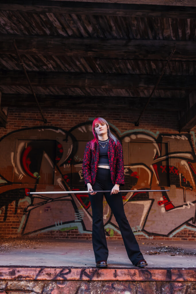 Kansas City senior photos in West Bottoms with graffiti wall backdrop