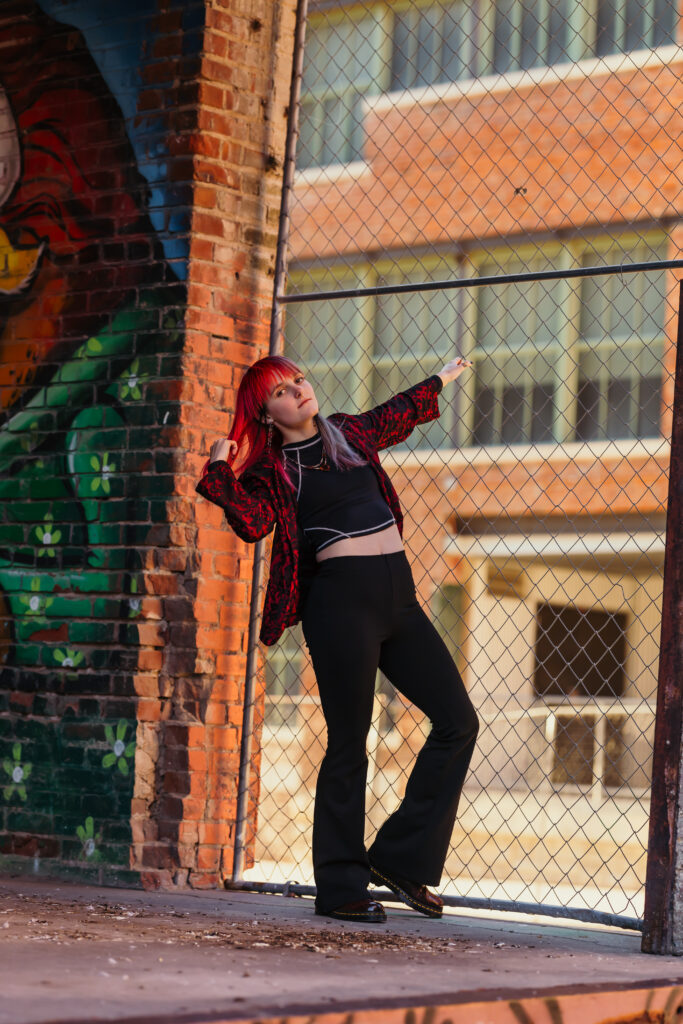 Senior girl posing in West Bottoms with city textures and graffiti