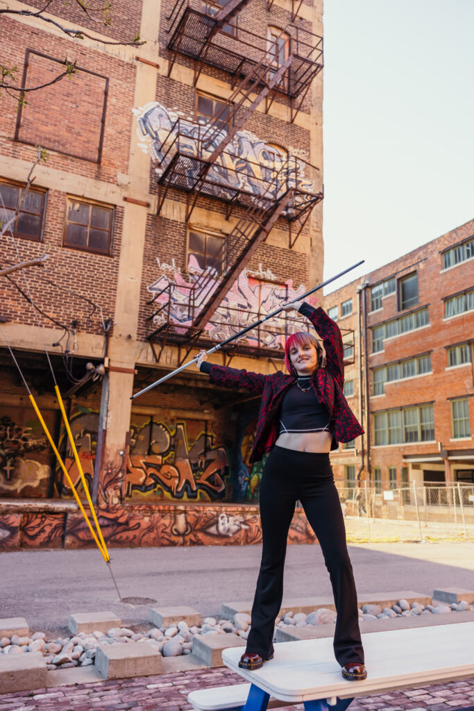 Kansas City senior posing with bo staff in urban setting