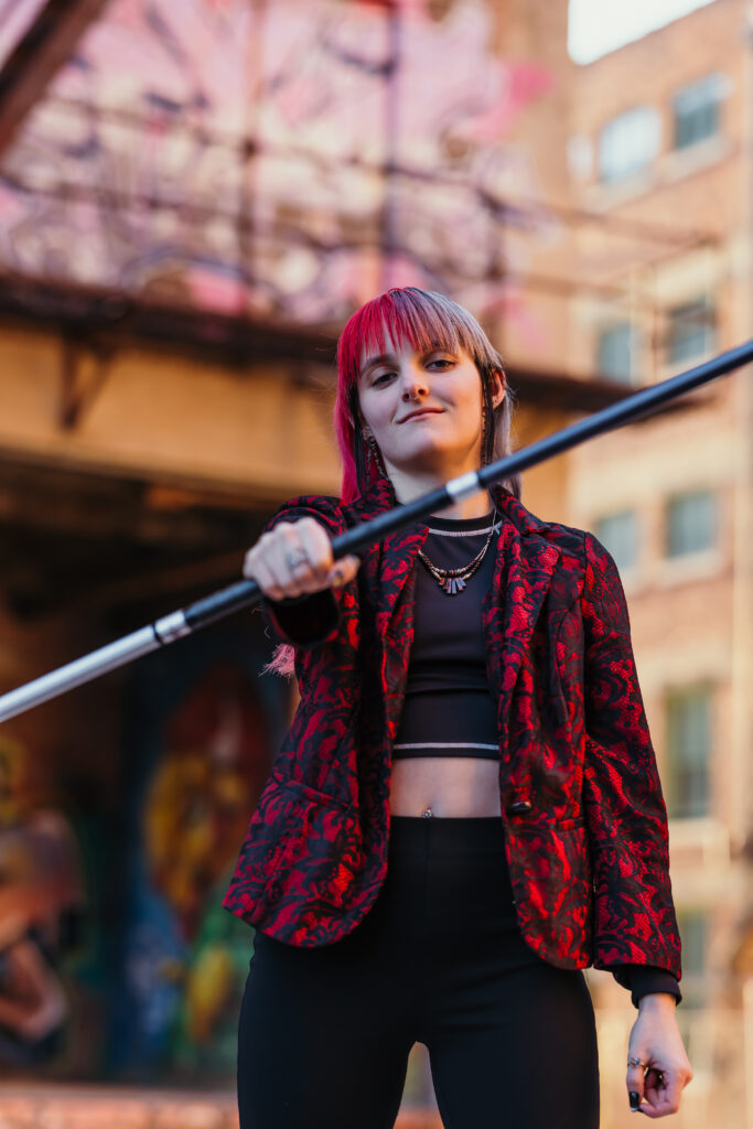 Kansas City senior posing with taekwondo bo staff