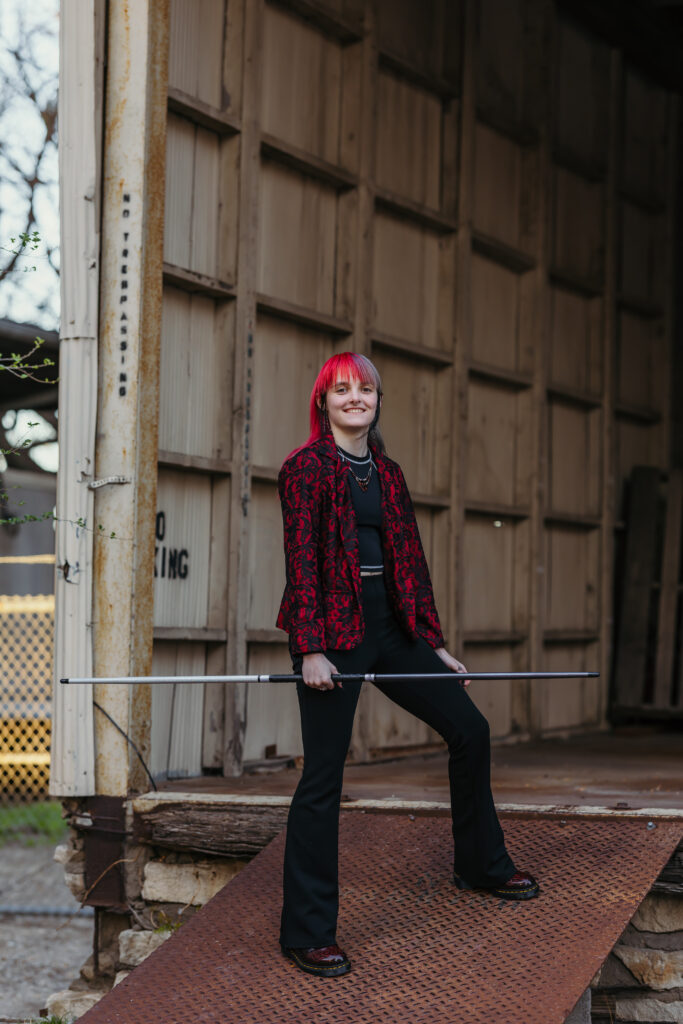 Senior girl showcasing martial arts skills in urban Kansas City setting