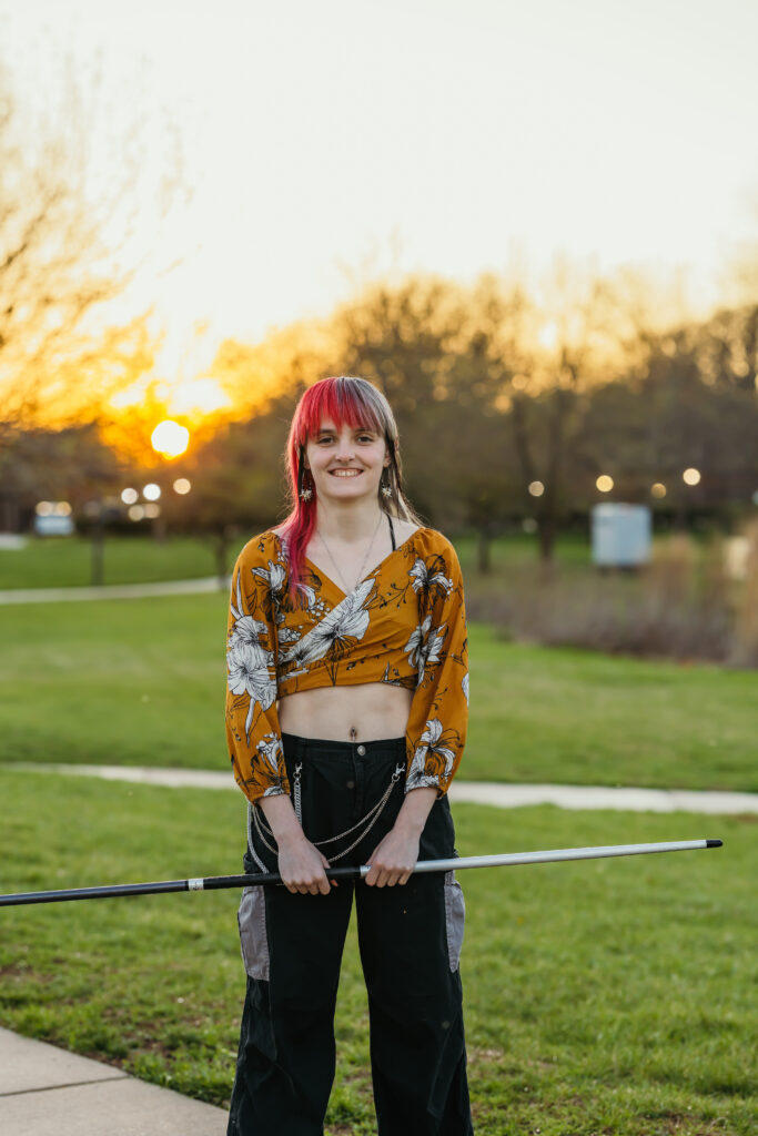Kansas City high school senior posing with bo staff in park