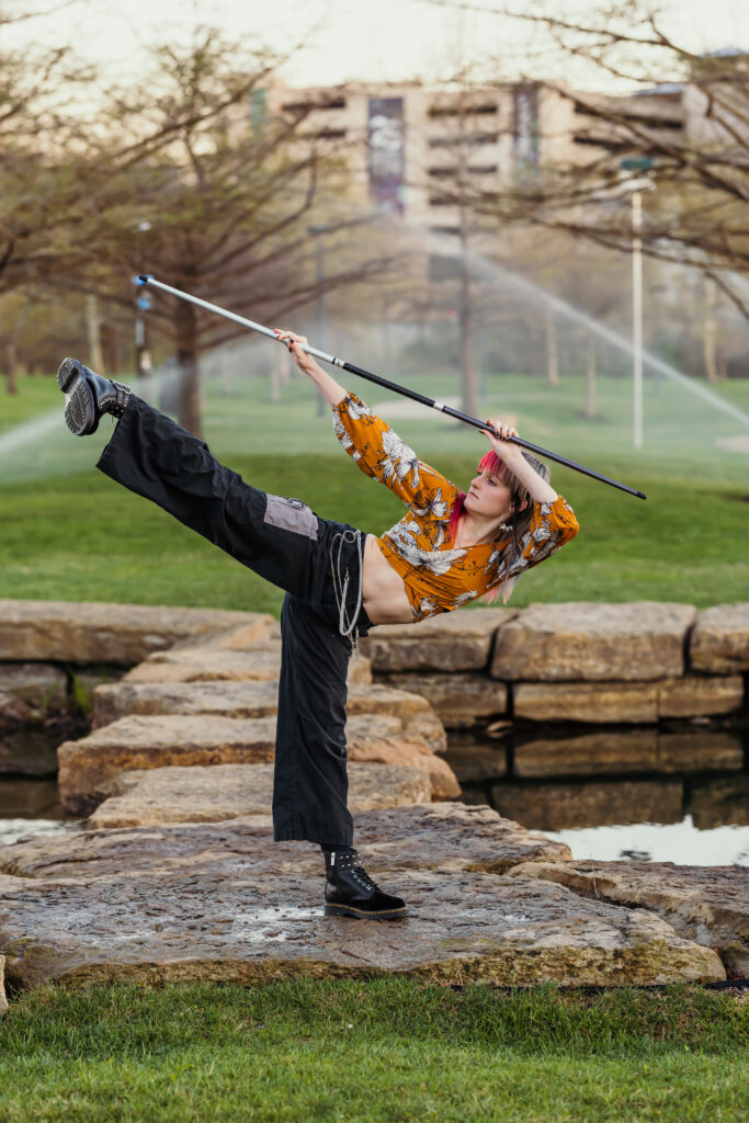 Kansas City senior photos featuring taekwondo martial artist with bo staff