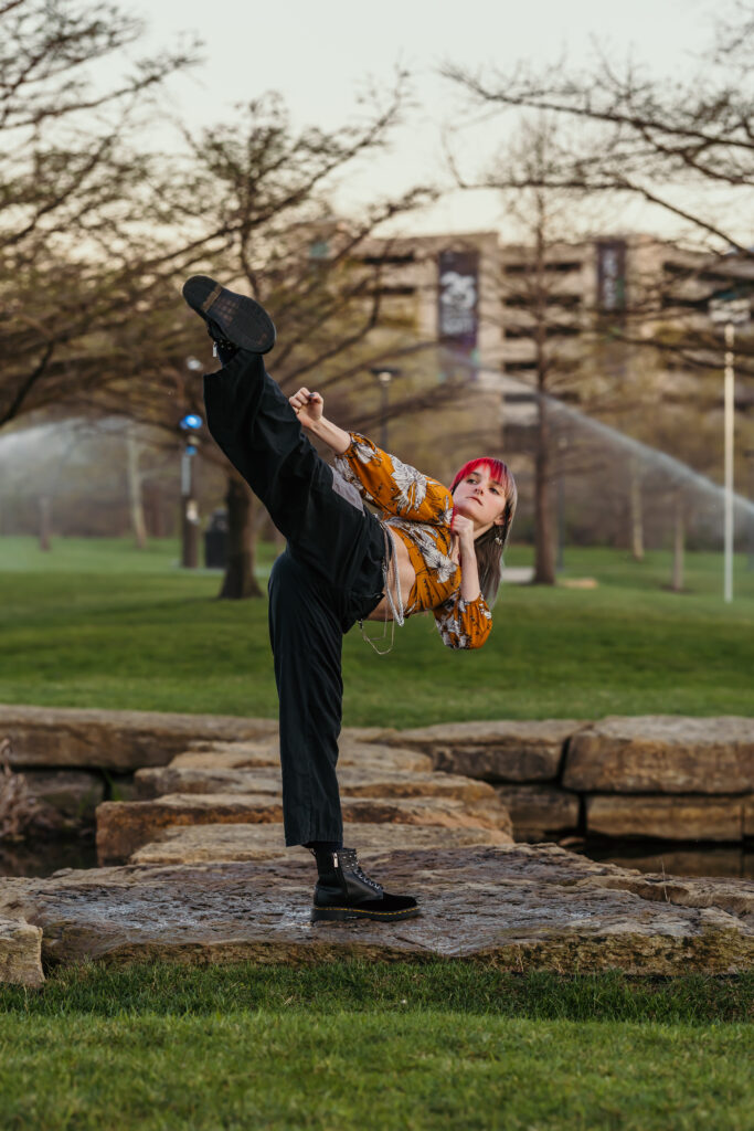 Senior girl showcasing martial arts skills in a Kansas City park