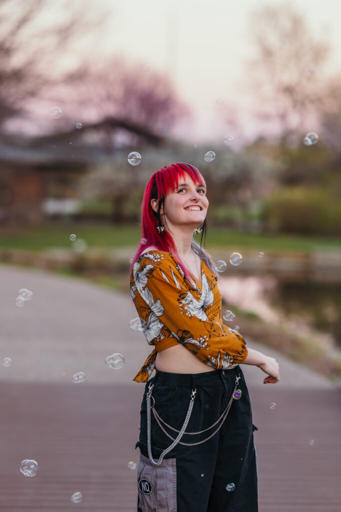 Candid senior photo with bubbles at golden hour in Kansas City
