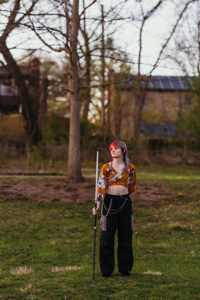 KC senior posing with bo staff at Anita B. Gorman Conservation Center