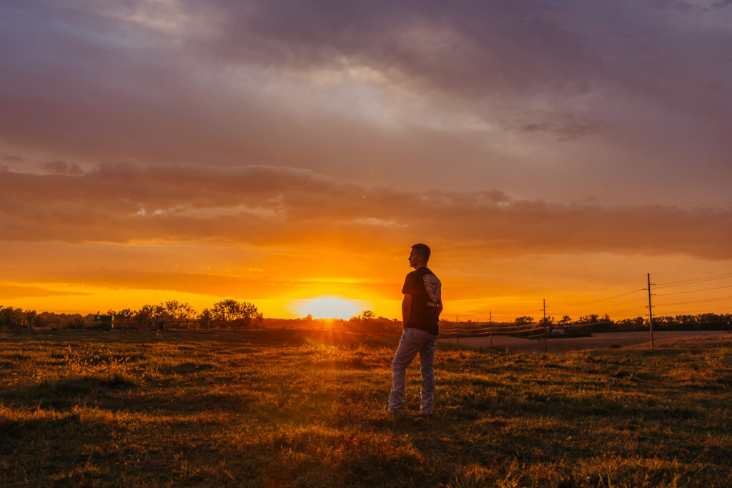 High school boy photographed at sunset golden hour