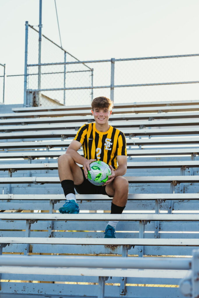 High school senior soccer player in bleachers for Kansas City senior portraits
