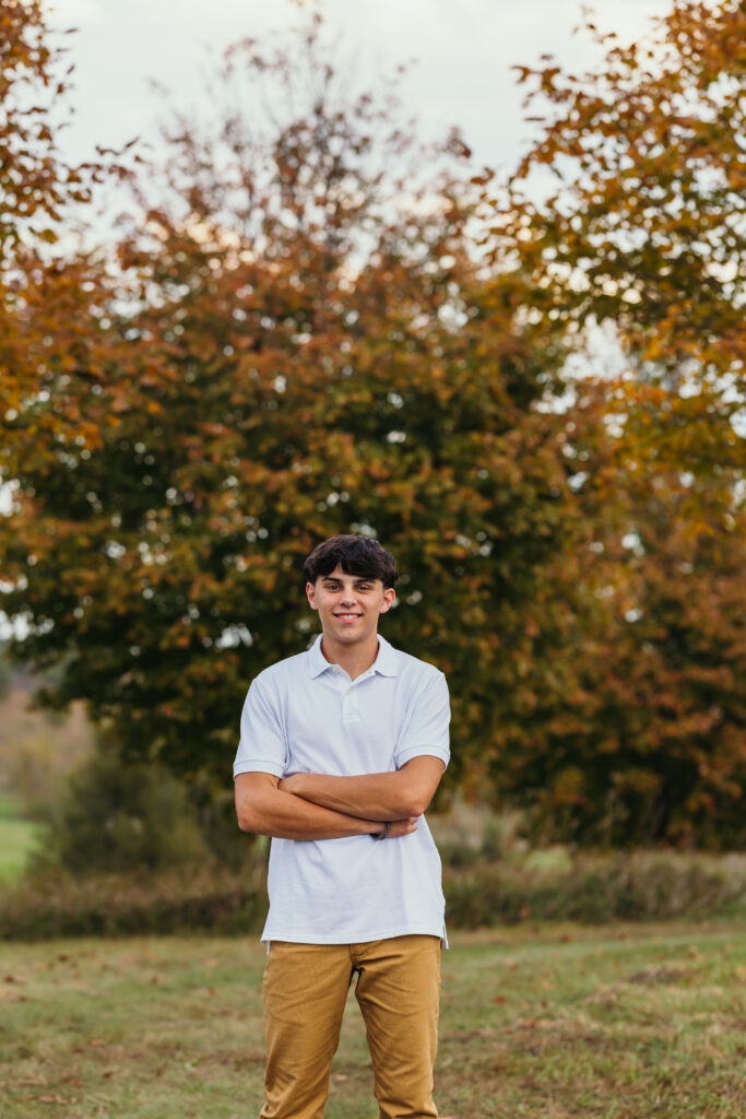 Kansas City high school senior posing in front of fall colors