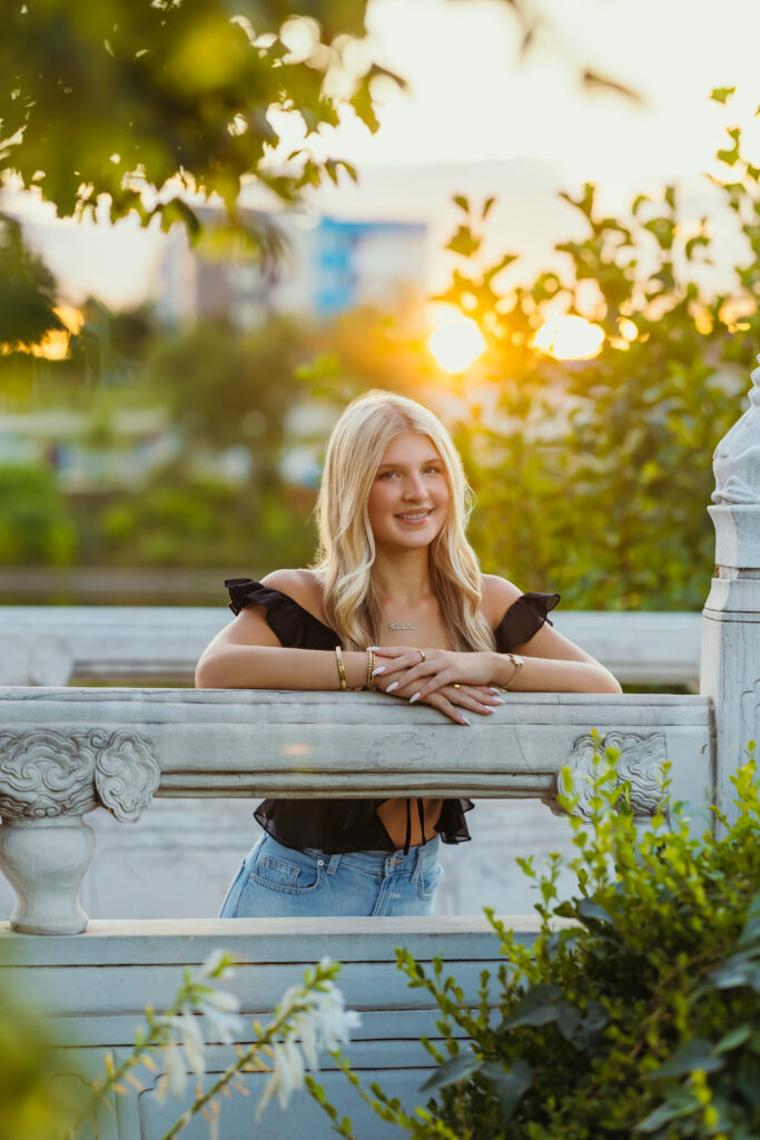 High school senior at park location during sunset golden hour