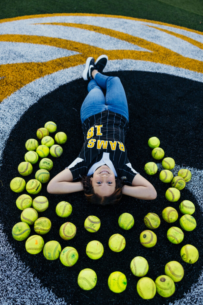 Female athlete senior session featuring softball uniform in Kansas City