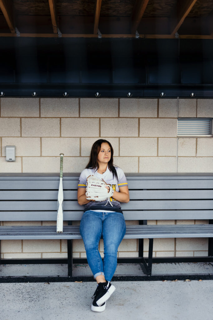 High school senior softball portraits in dugout and field in Kansas City