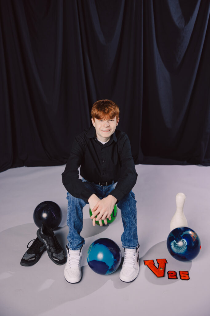 High school senior guy with bowling equipment during Kansas City studio session