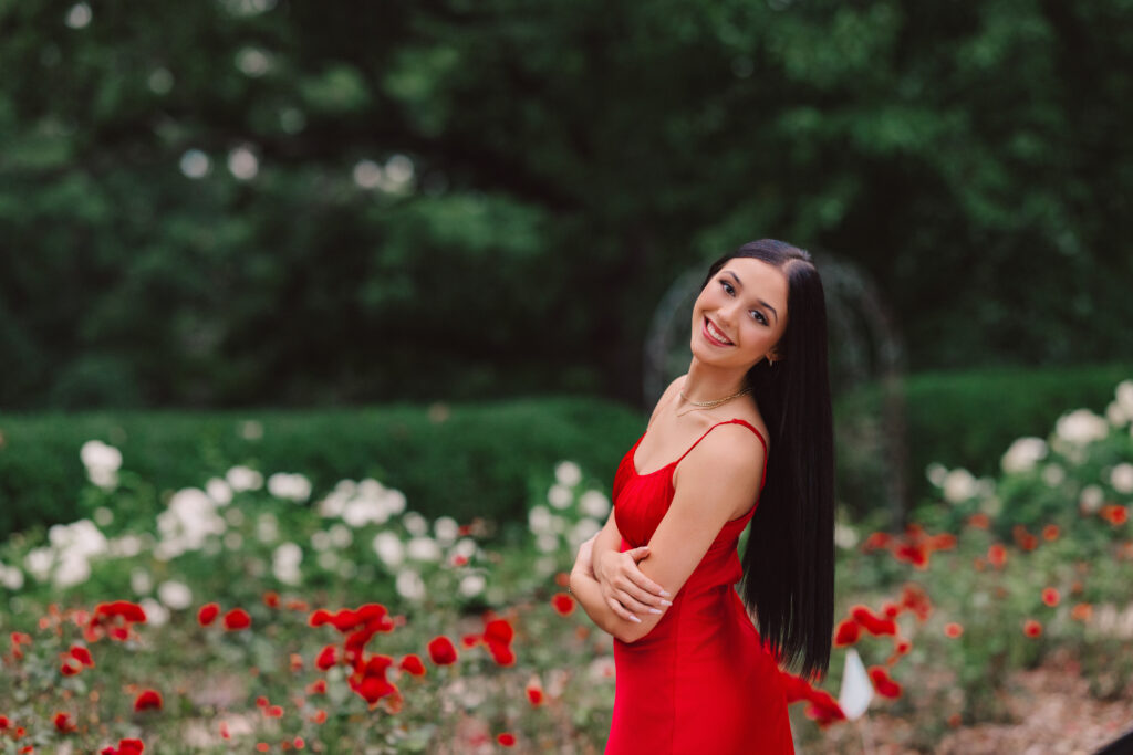 High school senior photo session with a red dress and roses