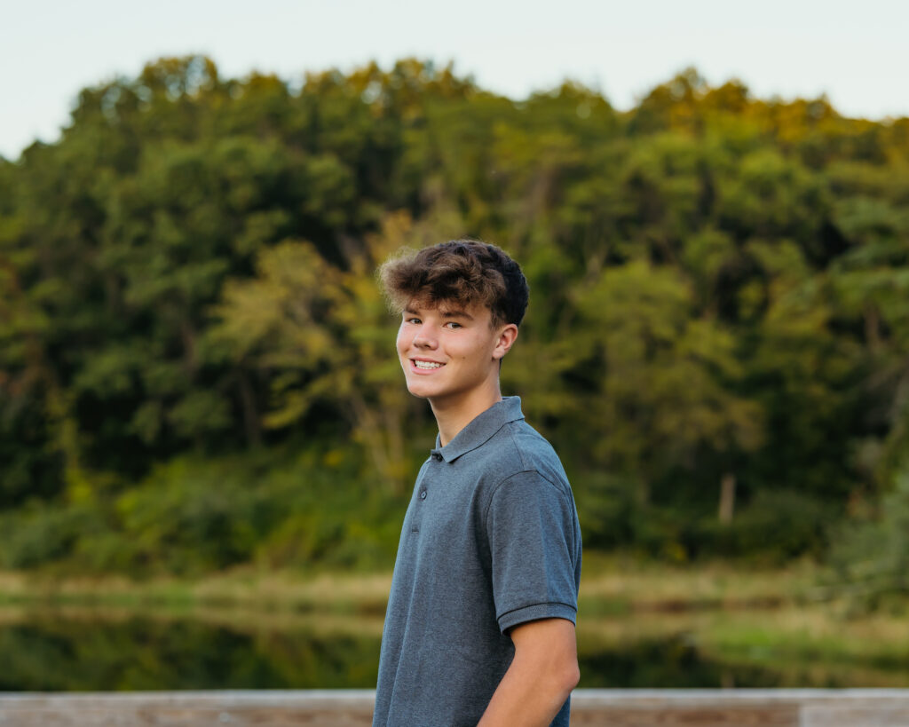 High school senior posing during golden hour photo session in KC