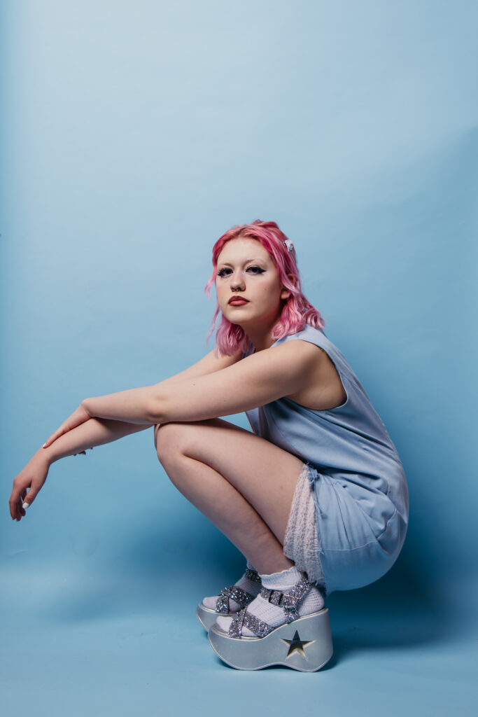 High school senior girl studio session with light blue background