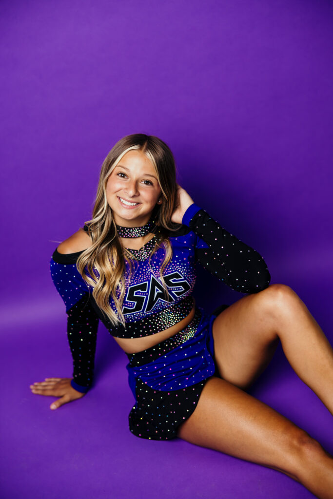 High school senior girl competitive cheer outfit during studio session