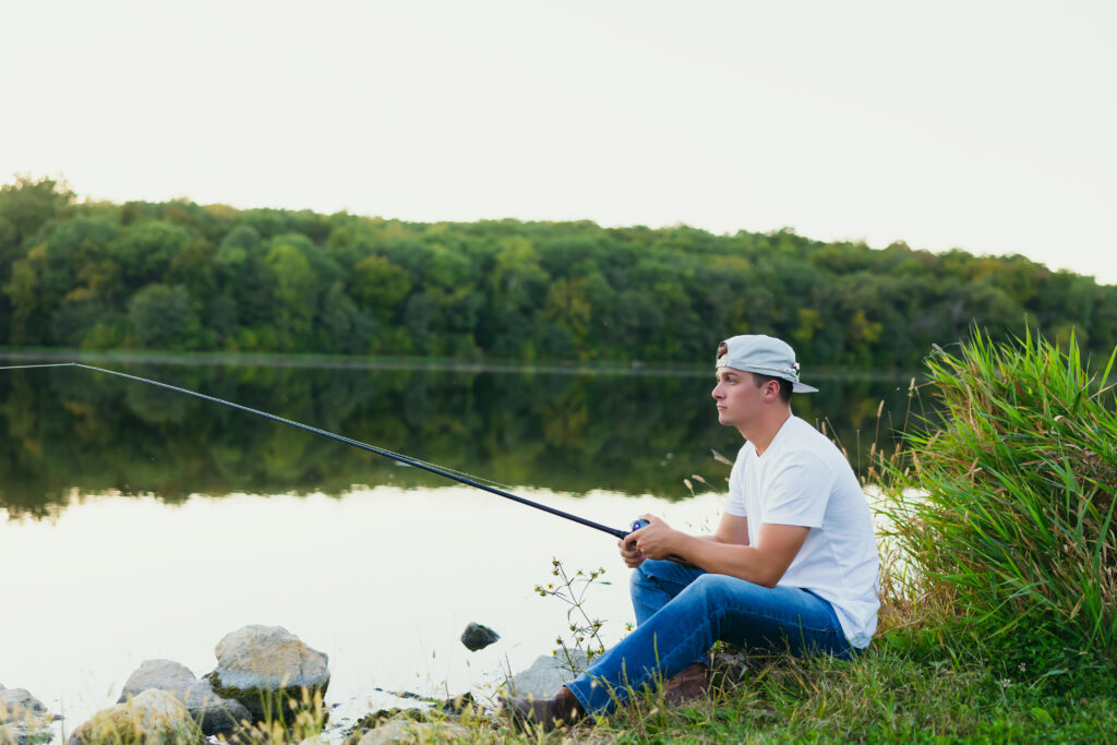 High school senior boy fishing during his senior session