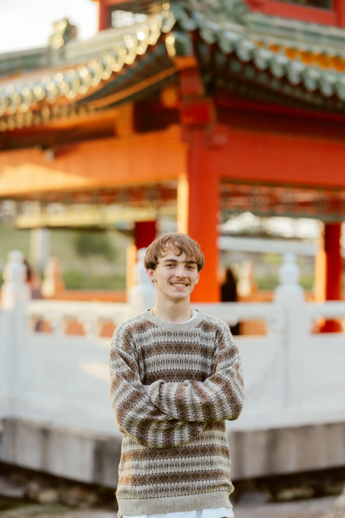 High school senior boy with stripped sweater in neutral colors
