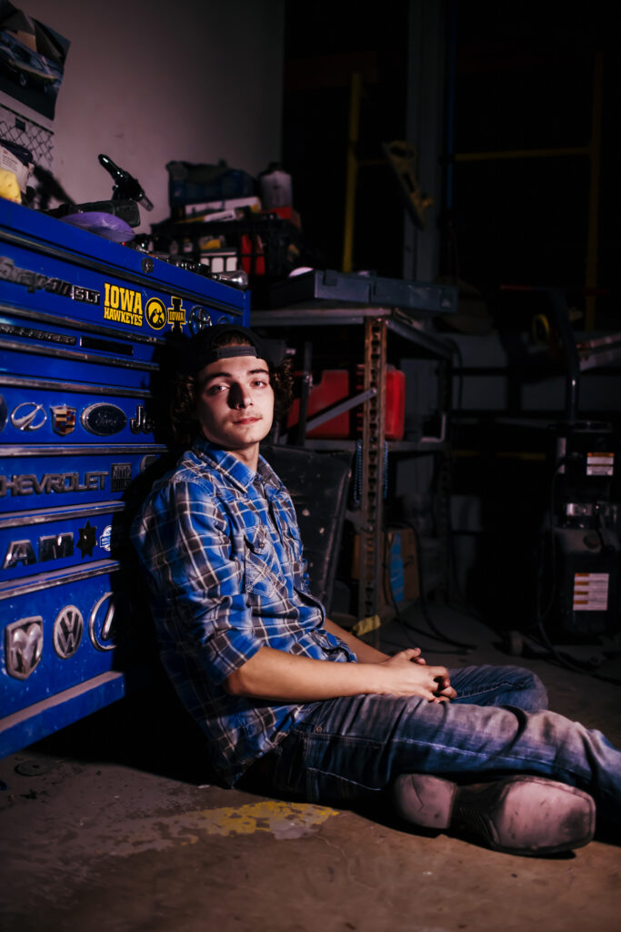 High school senior boy with car mechanic tools