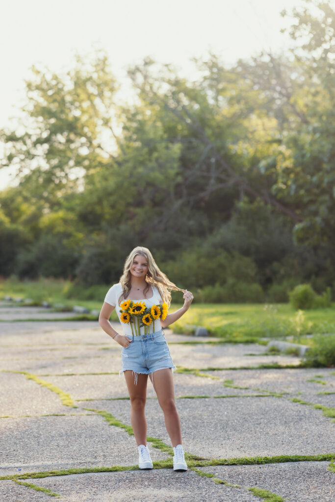 High school senior girl with sunflowers