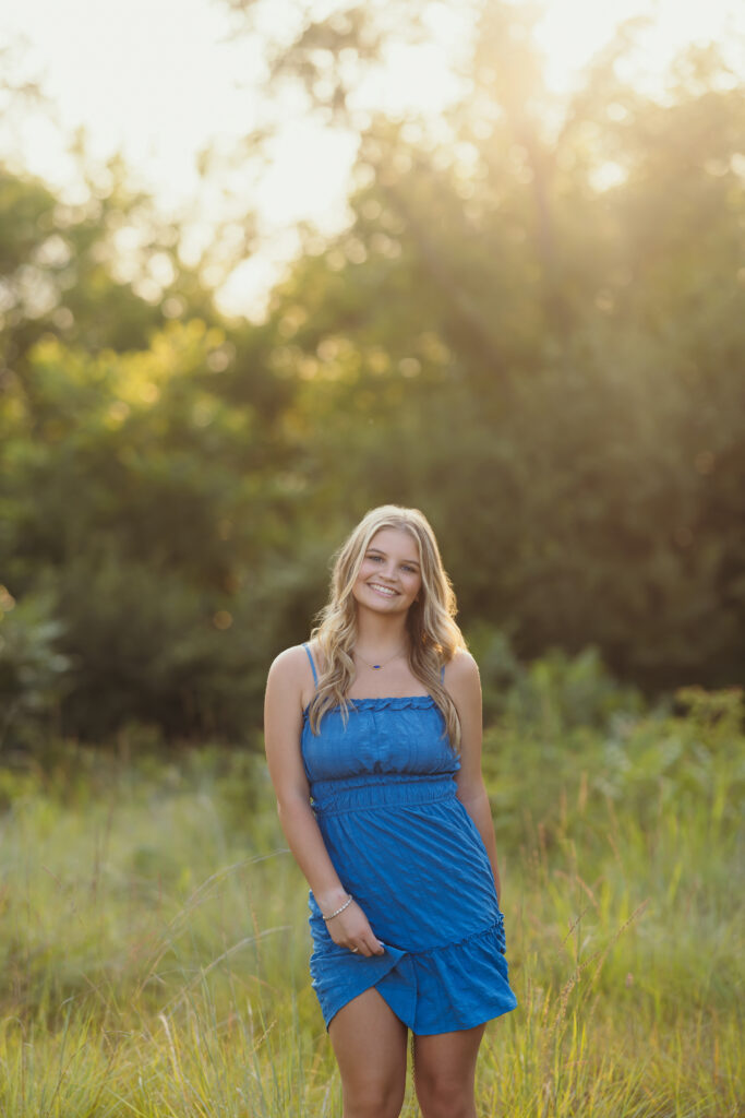 High school senior blue short dress in park setting