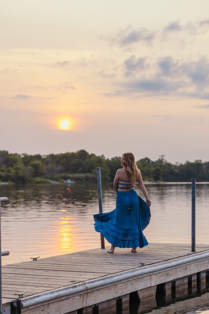 High school senior girl long flowy blue dress on the dock
