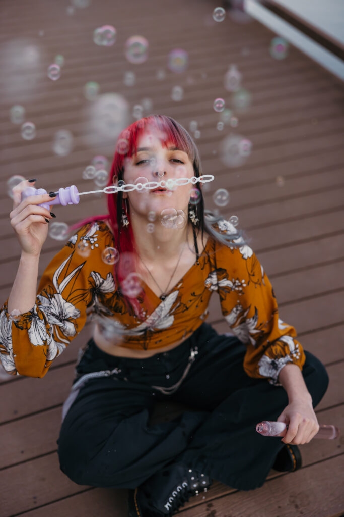 High school senior blowing bubbles
