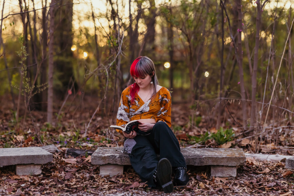 Kansas City high school senior girl reading a book during her senior photoshoot