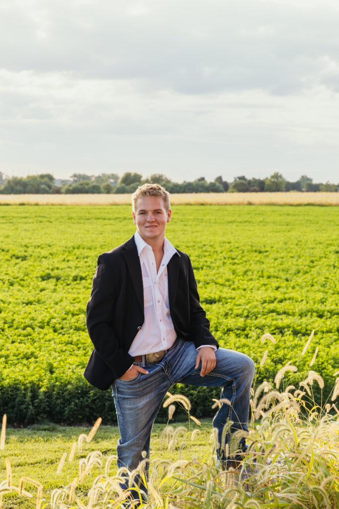 High school senior boy in rural setting with suit jacket