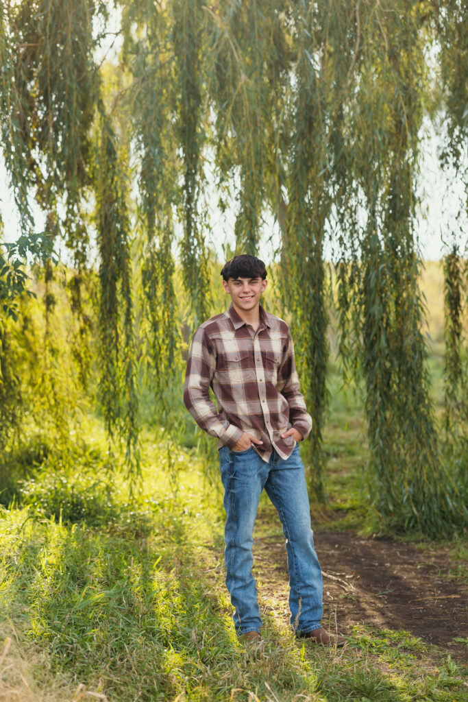 High school senior boy photo session at a park with plaid flannel shirt