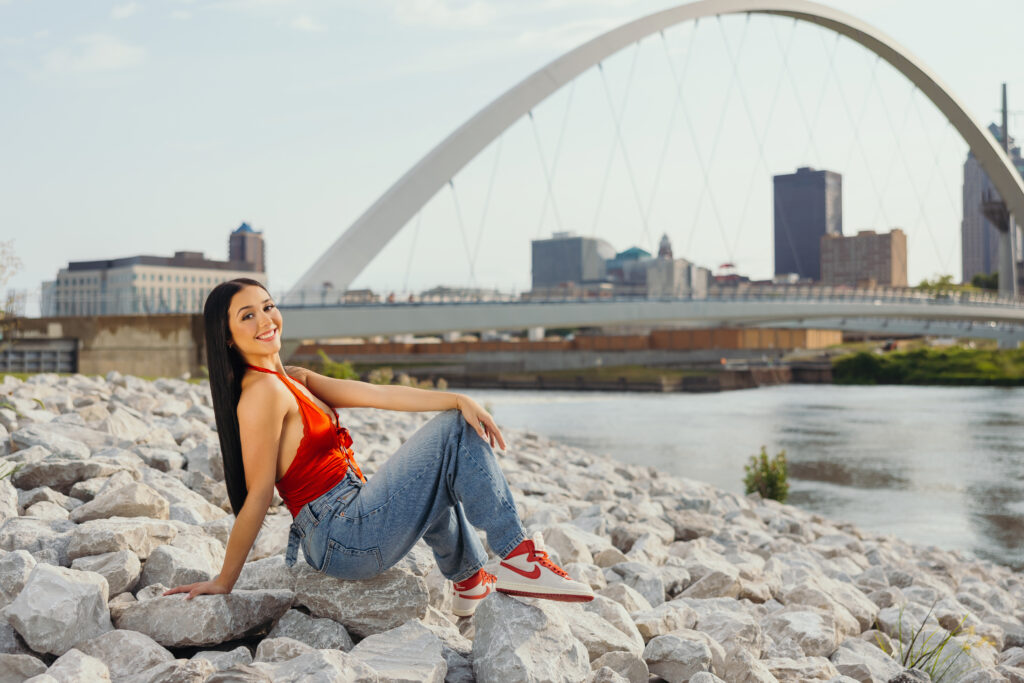 Senior high school girl in red top and jeans with Nike shoes