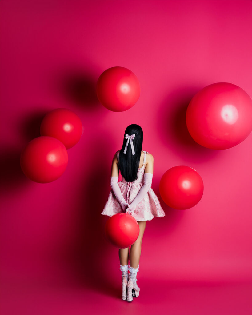 Pink studio session with balloons and bows and lace details for a Kansas City high school senior girl photoshoot