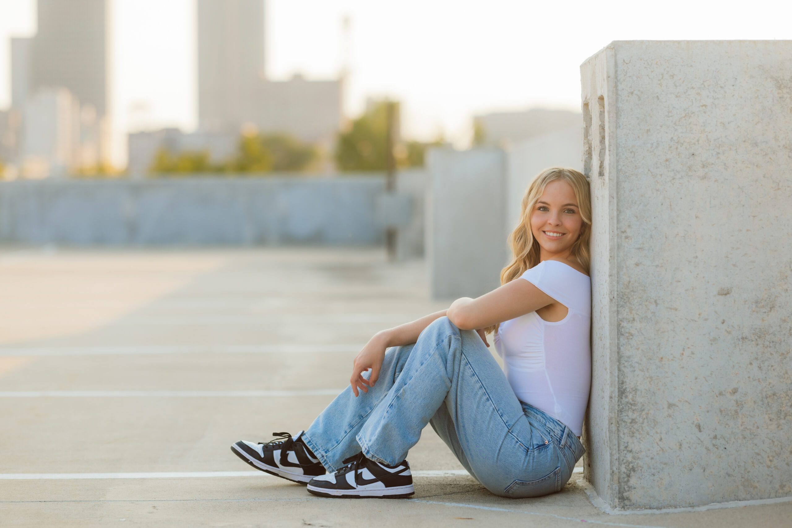 High school senior at golden hour on a rooftop of a parking garage