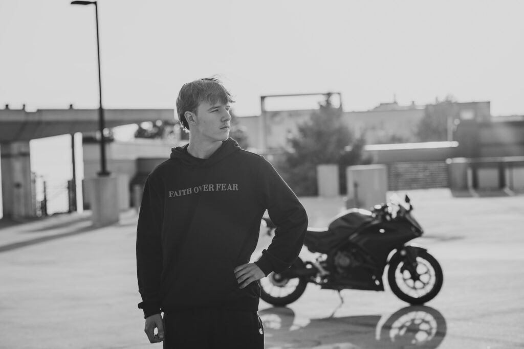 High school senior boy with his motorbike