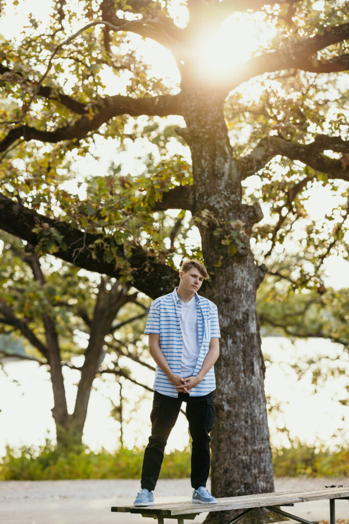 High school senior boy posing at golden hour