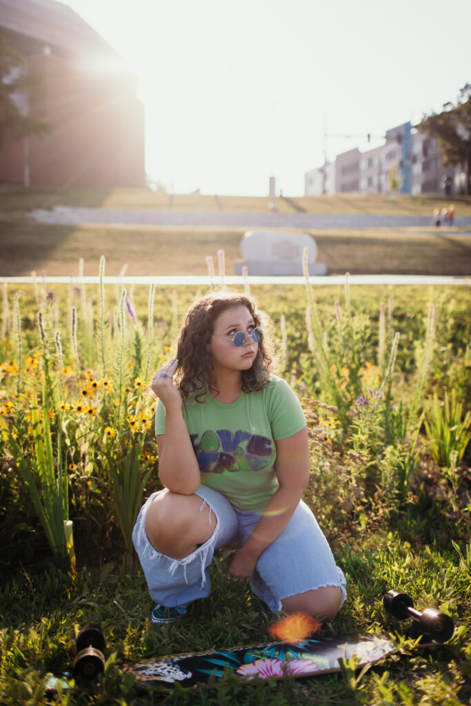 High school senior girl with her skateboard during senior photoshoot