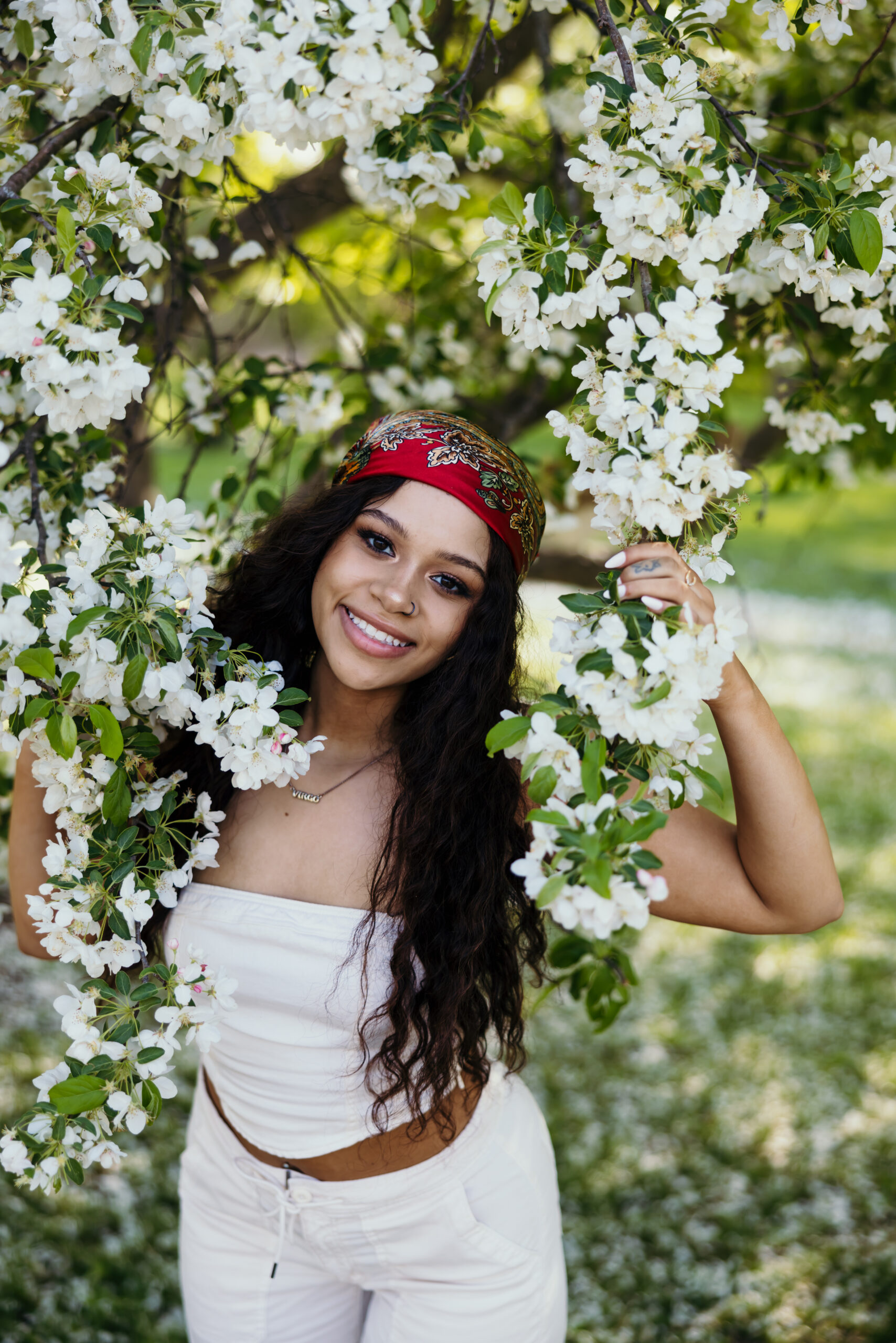 High school senior girl with red bandana and white spring blooms