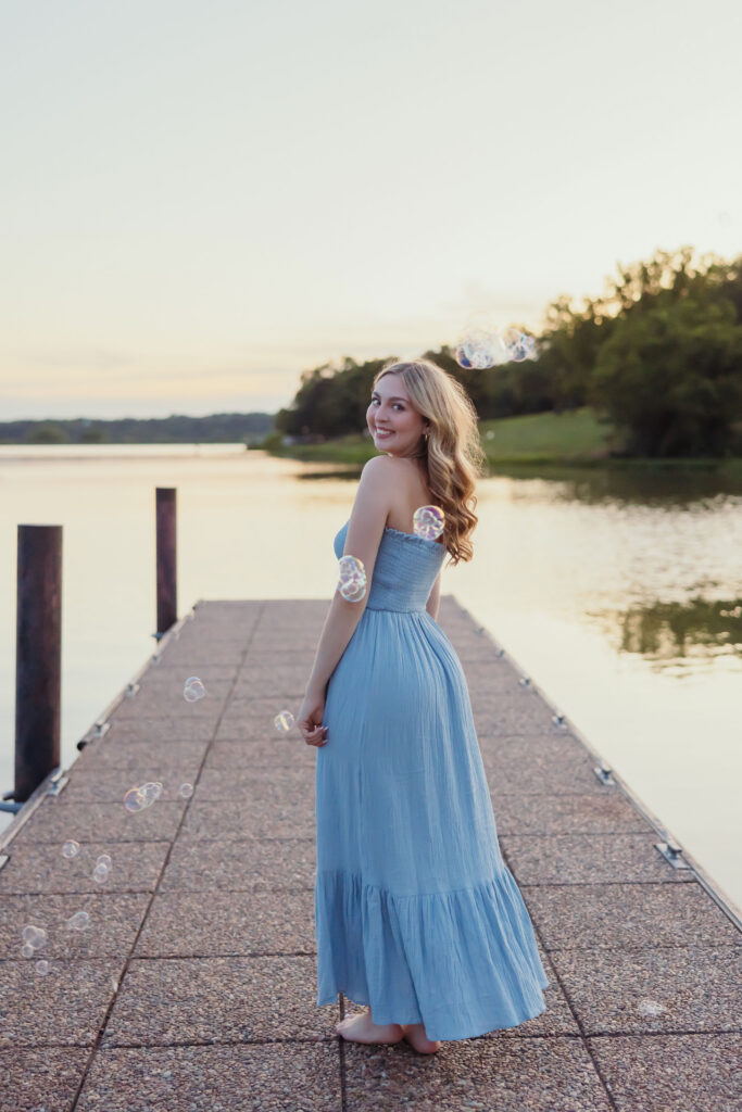 High school senior on the dock at Shawnee Mission Park lake in Lenexa Kansas